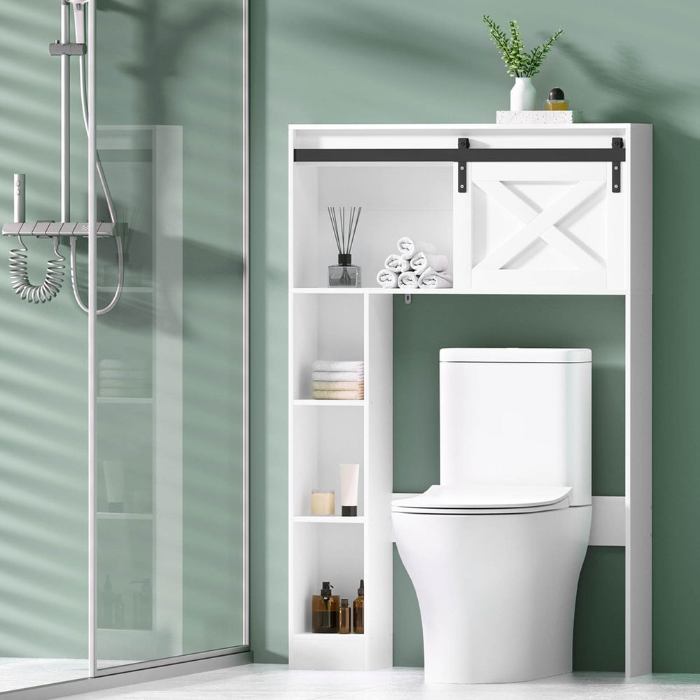 Bathroom with a toilet and storage cabinet against a green wall.