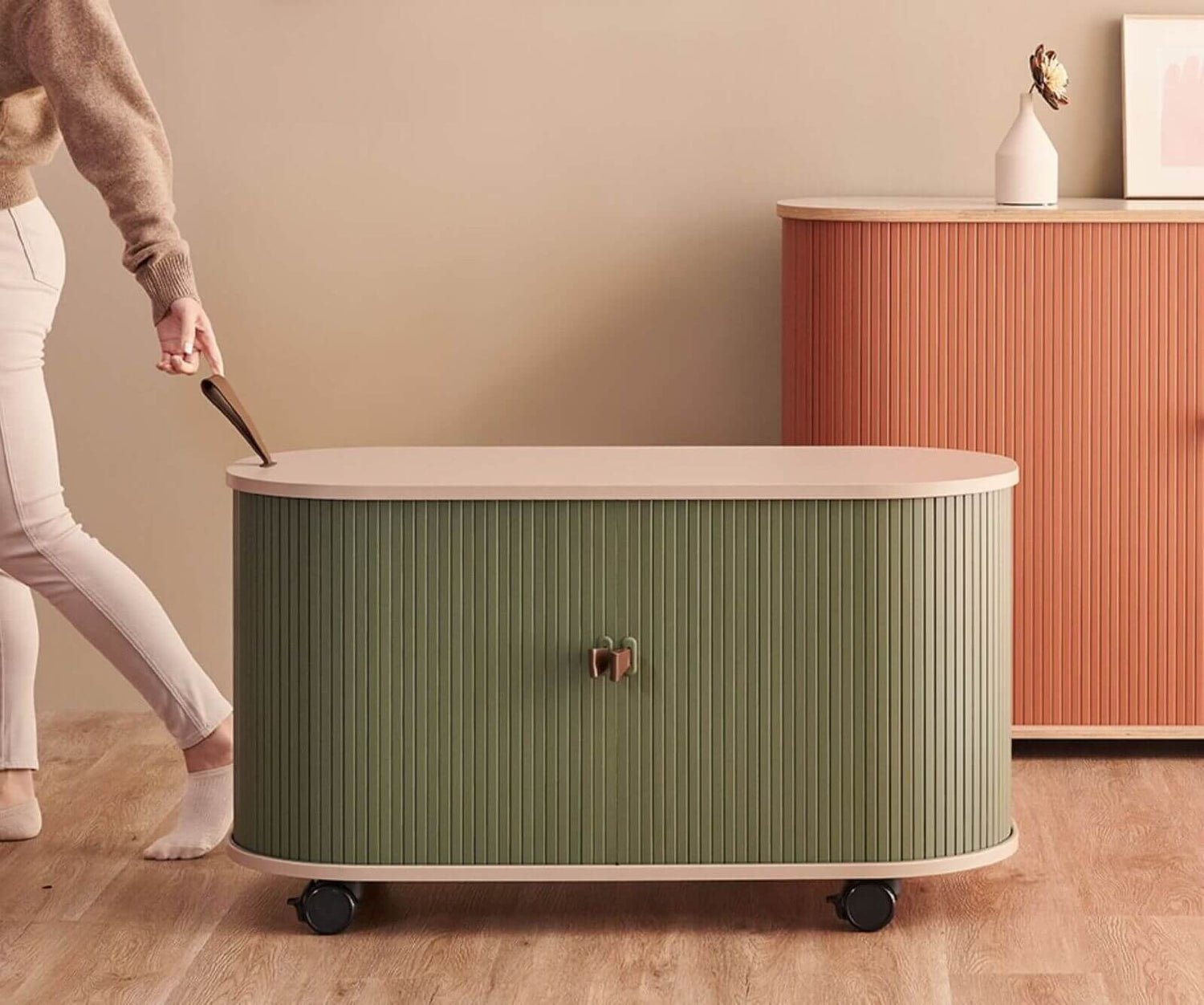 Laurel Green roller door storage cabinet being moved between rooms in small apartment