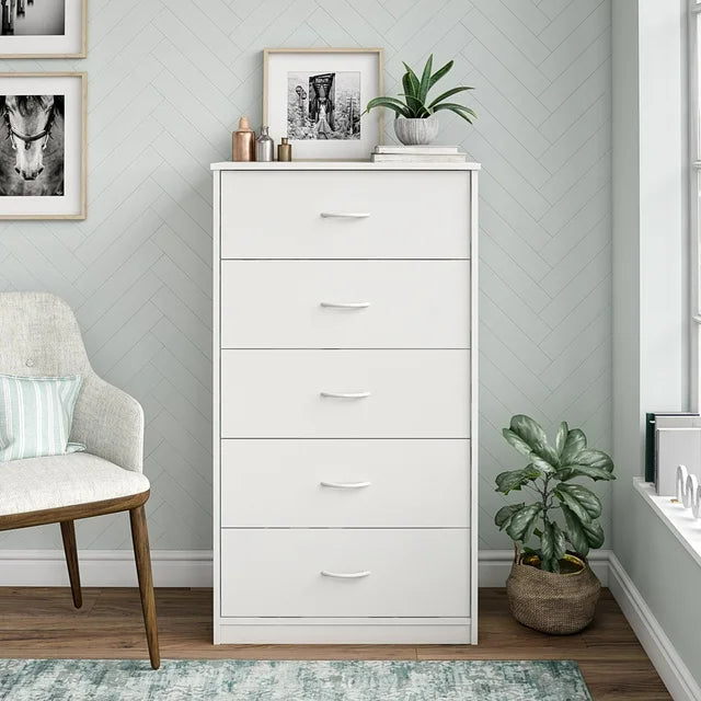 White bedroom cabinet with 5 drawers and metal handles – styled in living room
