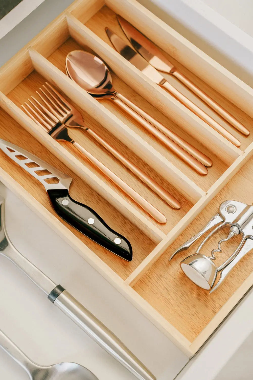 Adjustable bamboo cutlery tray showing extendable design for different drawer sizes