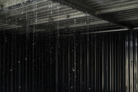 Condensation droplets inside metal shed roof with storage boxes below showing moisture damage prevention solutions