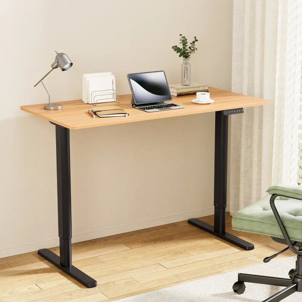 Modern electric standing desk setup in Australian home office with laptop and minimal workspace organization