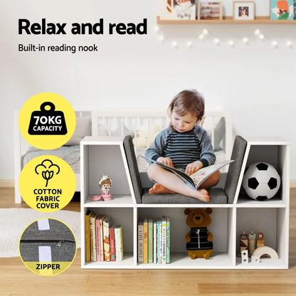 Child sitting on bookshelf reading seat surrounded by organized books and toys