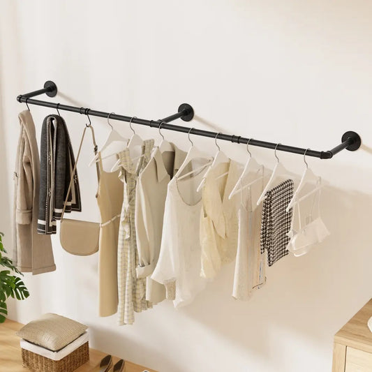 Black floating shelf clothes rack in entryway with coats jackets and bags organized