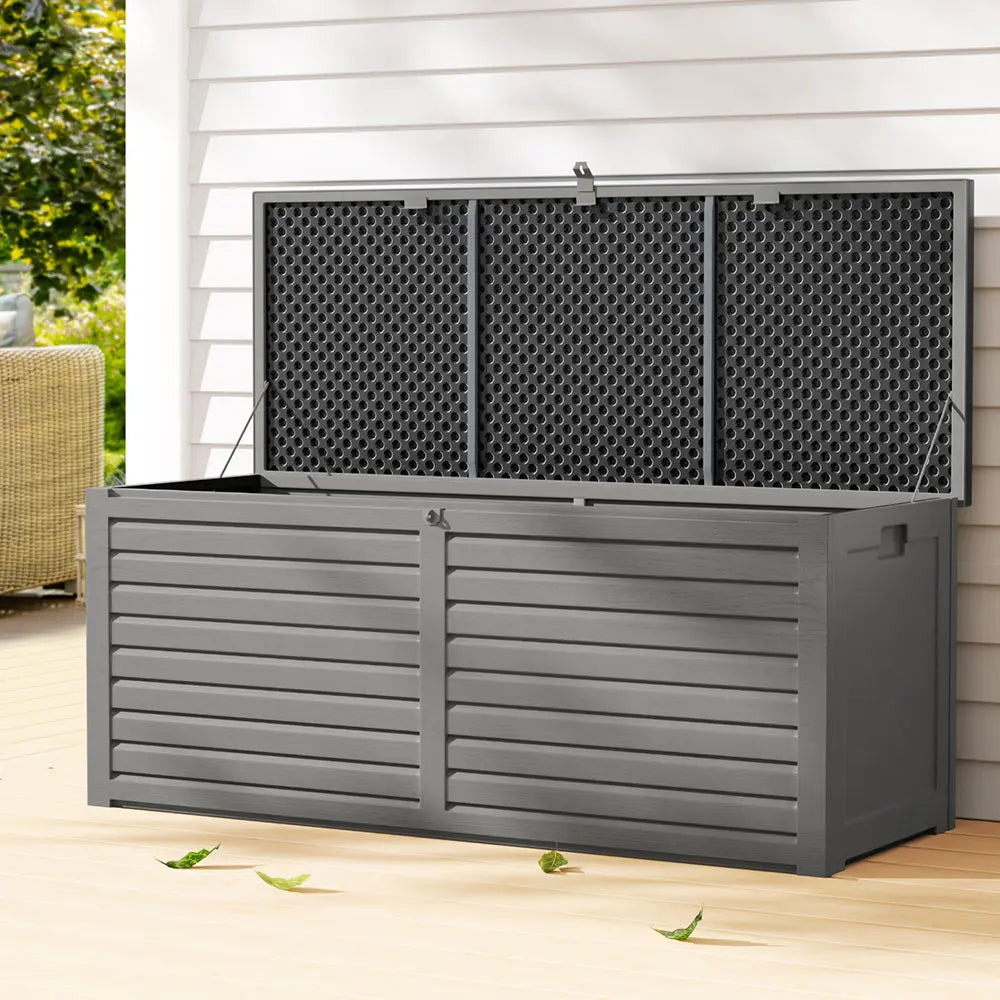 Outdoor storage box bench near swimming pool storing pool toys, floats and beach towels in Australian backyard