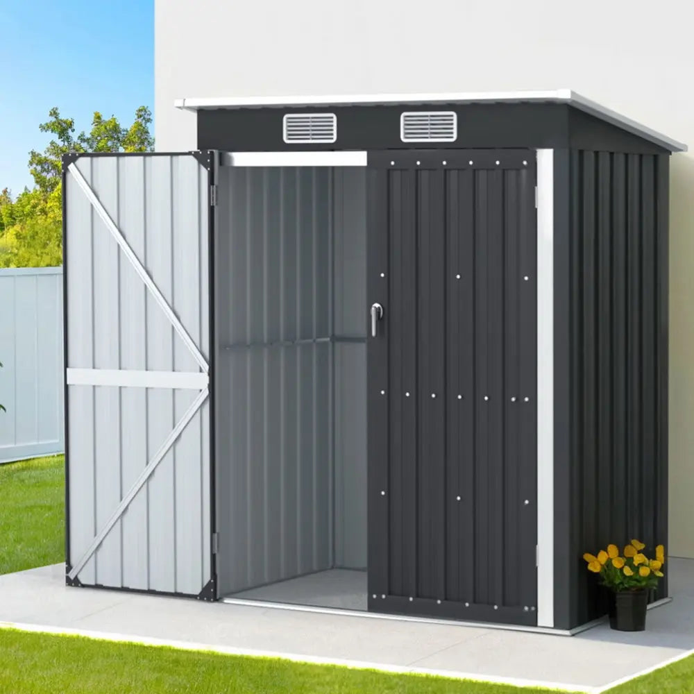 Installed garden shed in Australian backyard setting showing compact footprint and professional grey finish complementing home exterior