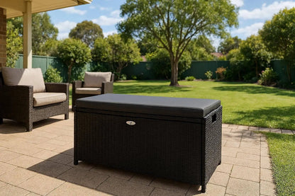 Gardeon black wicker storage bench on outdoor deck with cushion showing outdoor furniture styling