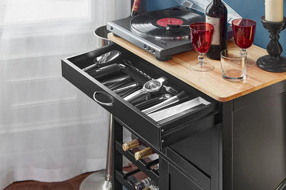 Open drawer and cupboard storage compartments in kitchen trolley showing organizational space for entertaining essentials