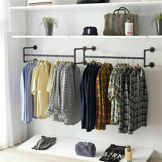 Black industrial wall mounted clothes rack with shelf holding jackets and coats in modern bedroom