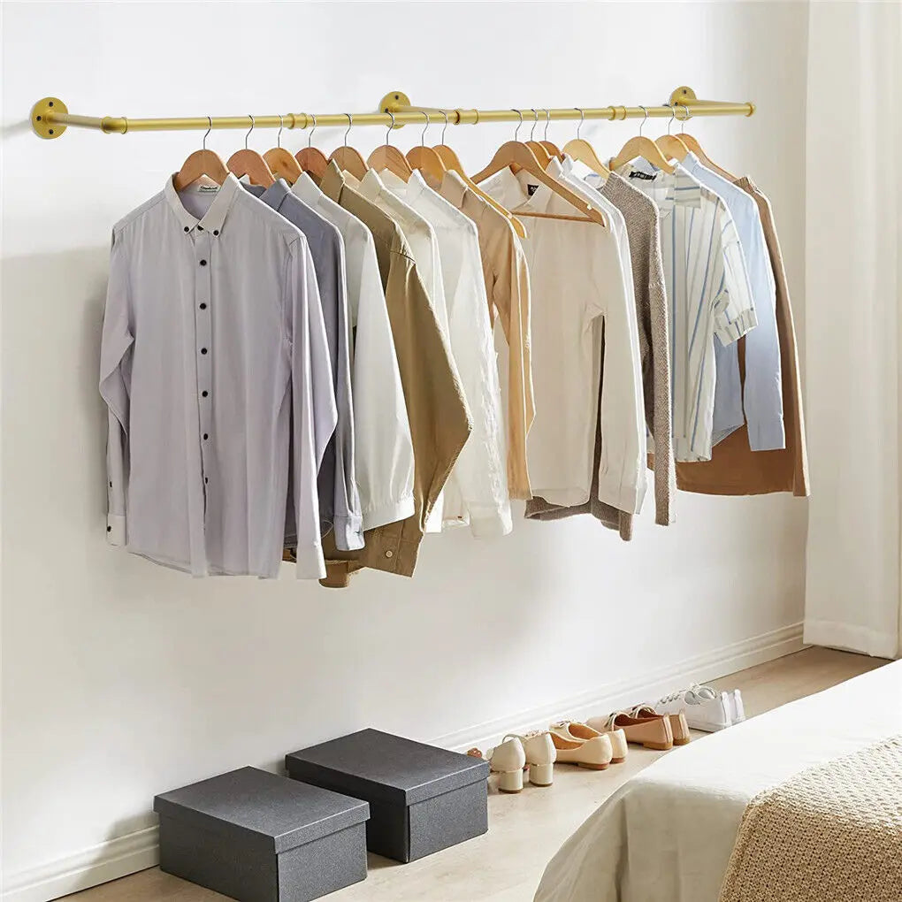 Gold wall mounted clothes rack with vintage industrial design hanging coats in hallway