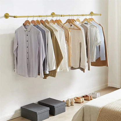 Gold wall mounted clothes rack with vintage industrial design hanging coats in hallway
