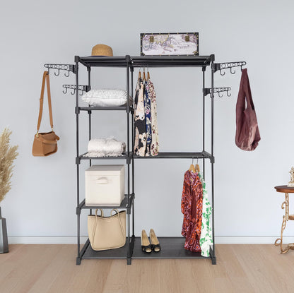 Black multi-tiered clothing rack with various items on a light wooden floor and light gray wall background.